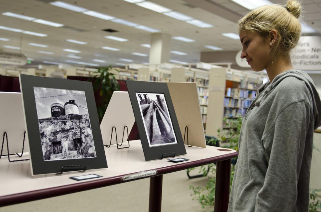Camille Dupuis, who visited Cuba in the Study Abroad program, takes a look at the photographs displayed in the Library.