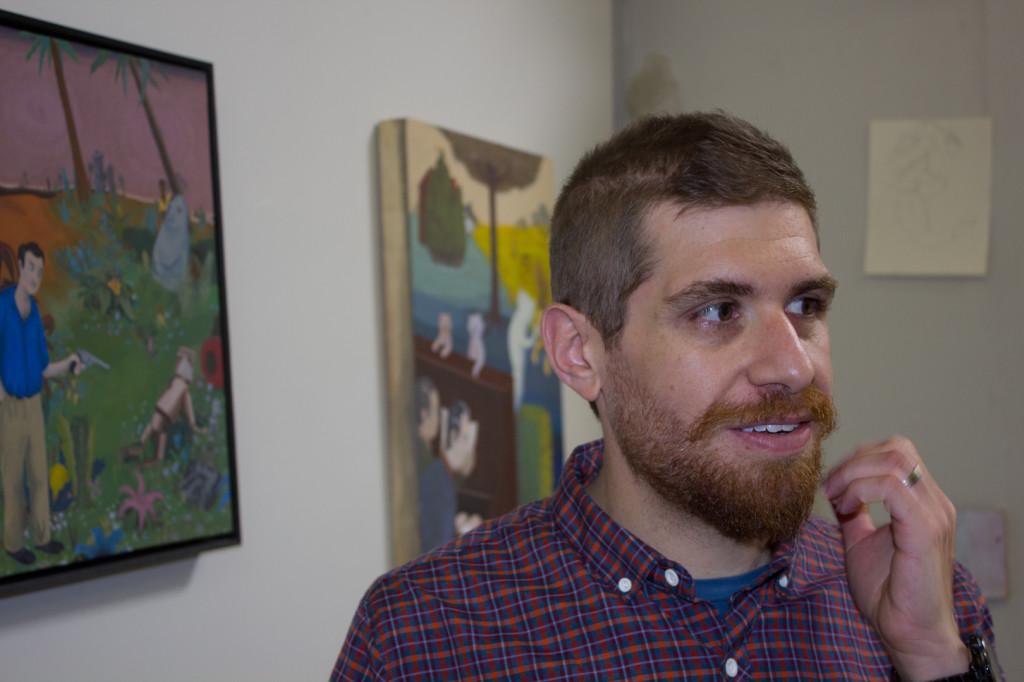 Christopher Ulivo stands in front of his painting Nixon 42 (left) in his garage studio in Goleta.