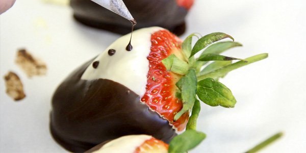 Chocolate accents are added to a tuxedo strawberry during the chocolate making class hosted by the City College Culinary Club, March 9, 2013 in the Campus Center.