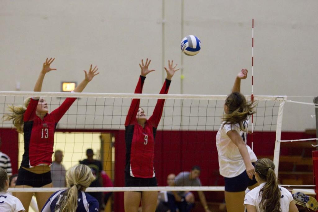 The Vaqueros middle blocker Kristy Kearney, No. 13, and outside hitter, Tomilyn Ryba, No. 9, blocks a shot from Irvine Valley Colleges middle blocker Haley Whyte, No. 13, during a match in the Life Fitness Center at City College in Santa Barbara, Calif. on Friday, Sept. 6, 2013.