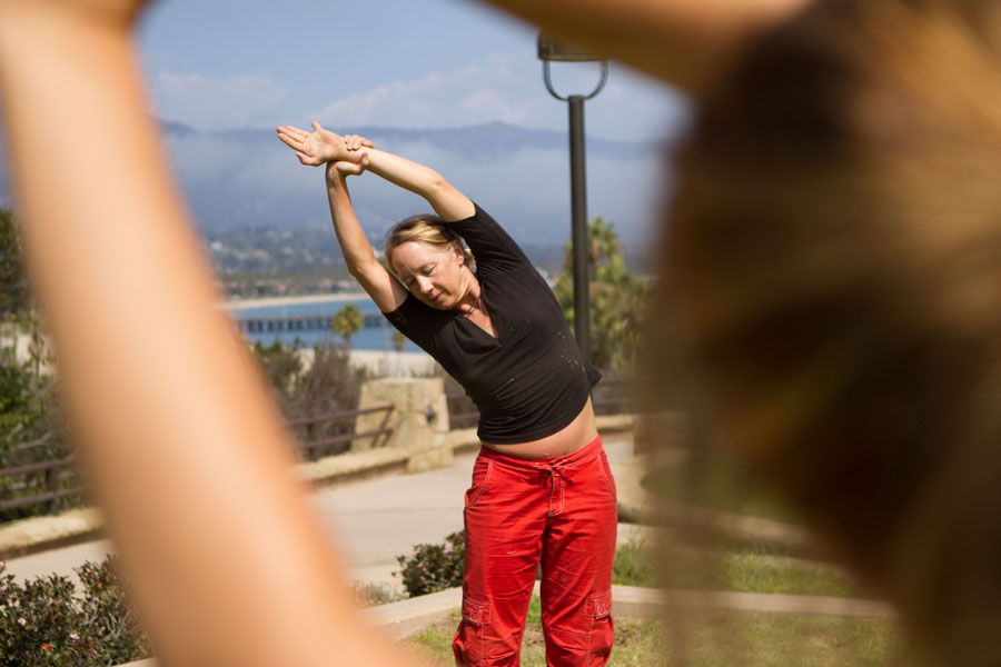 Betsy Phillips shows students how to perform a half moon pose during her free yoga session hosted on the Winslow Maxwell Overlook at City College on Monday, Sept. 9, 2013 in Santa Barbara, Calif.