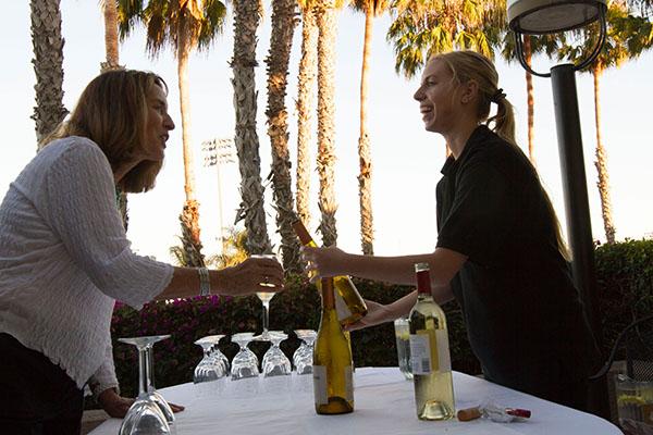 Lacie Smith serves wine to Judy Edner at the Food for Thought Dinner, in the John Dunn Gourmet Dining Room, on Sept. 16, 2013. This event raises money for the culinary students from the Julia Childs endowment. White wines are considered beautiful according to the world of asthetics , said by Joe White (Head Chair of the Philosophy Dept.)