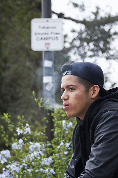 Jesus Perez exhales a puff of cigarette smoke, on City College campus, on Sept. 10, 2013. Smoking has recently been prohibited campus-wide even in formerly designated areas.