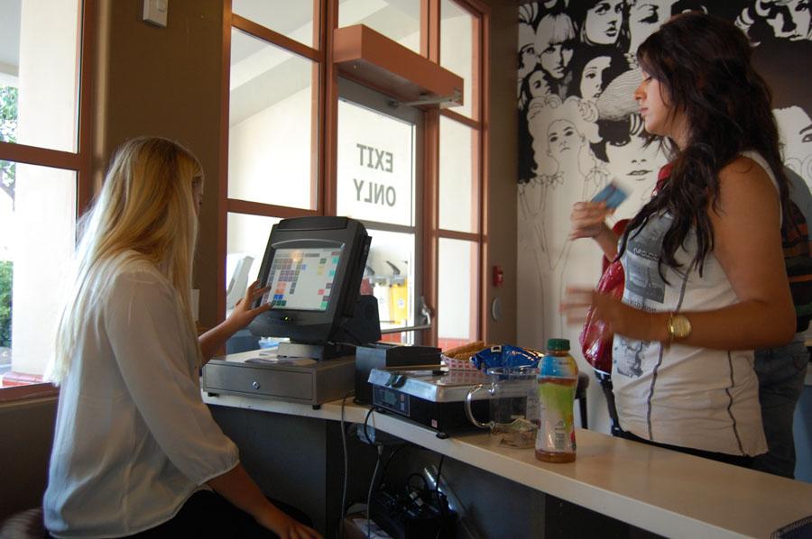 Kira Rudderow, 19, public relations student, rings up Estela Cervantes, 22, psychology student, at City College on Wednesday, September 11, 2013 in Santa Barbara, Calif.