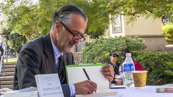 Hooman Majd signing books in an Administration Building courtyard on Santa Barbara City College’s East Campus in Santa Barbara, California on October 10, 2013 between 4:00pm and 5:00pm.