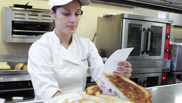 Stephanie Olsen, 25, culinary arts major, reads an order in the JSB Cafeteria at City College on Tuesday, Nov. 6, in Santa Barbara (Calif.) The JSB is an entirely student run cafeteria. 