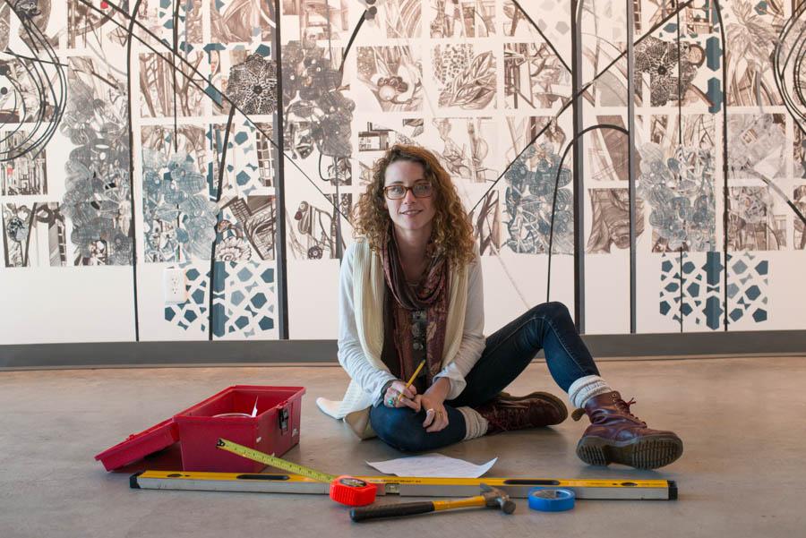 Art Intern, Lia DeWit, 22,  works in the Atkinson Gallery on her first curated exhibit, Chaos and Creation, Monday, Feb. 10. Chaos and Creation can be viewed in the John Dunn Gourmet Dining Room.