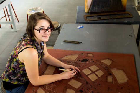 Sasha Colbert, carving up her latest woodwork creation on Feb. 20, in the Humanities Building Print Making Lab at City College.
