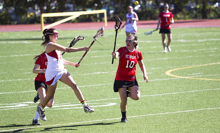 City College lacrosse player Megan McCullough (No. 8) races to catch the ball against College of St. Benedict on Friday, Feb. 14, 2014, at La Playa Stadium in Santa Barbara, Calif.  The Vaqueros lost 10-8. 