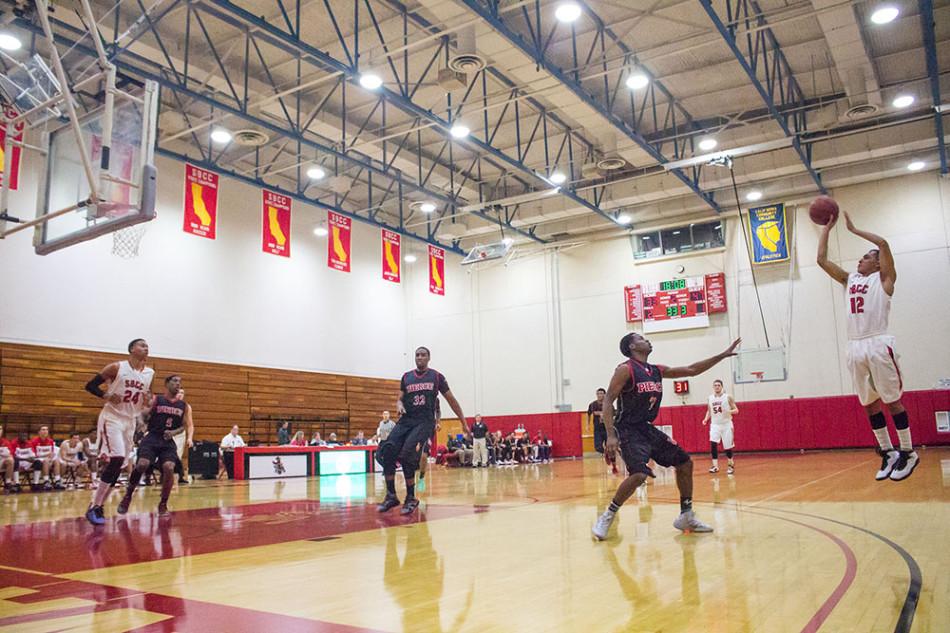 City Colleges sophomore guard, Pablo Miranda (No. 12), attempts a three-point shot against Los Angeles Pierce College on Saturday, Feb. 22, in Santa Barbara. Miranda finished the game with 10 points as the Vaqueros lost to the Brahmas 96-87.