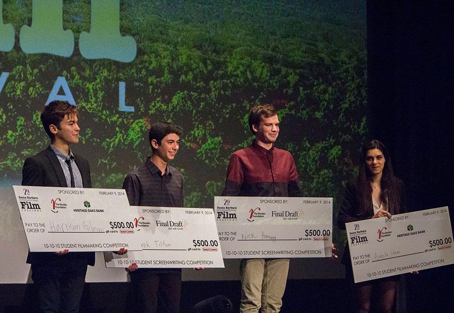 Winners of the 10-10-10 film competition, Harrison Gilman (from left), Derek Tilton, Nick Hornung and Ayasylla Ghosn receive their gift certicates to Samy's Camera. The romantic comedy themed competition took place in the Arlington Theater on Sunday, Feb. 9.