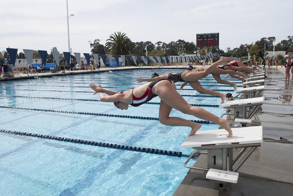 City College’s Emily Foster (closest) competes in the womens 100-yard freestyle during the Western State Conference Pentathlon on Feb. 15, 2014, at the Ventura Aquatic Center in Ventura, Calif.