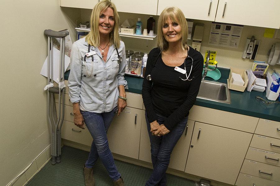 Pamela Johnson (left) and Patrice Irving stands in a exam room in the Health Center on Wednesday, Feb. 12, at City College in Santa Barbara, Calif. The twins work as nurses together.