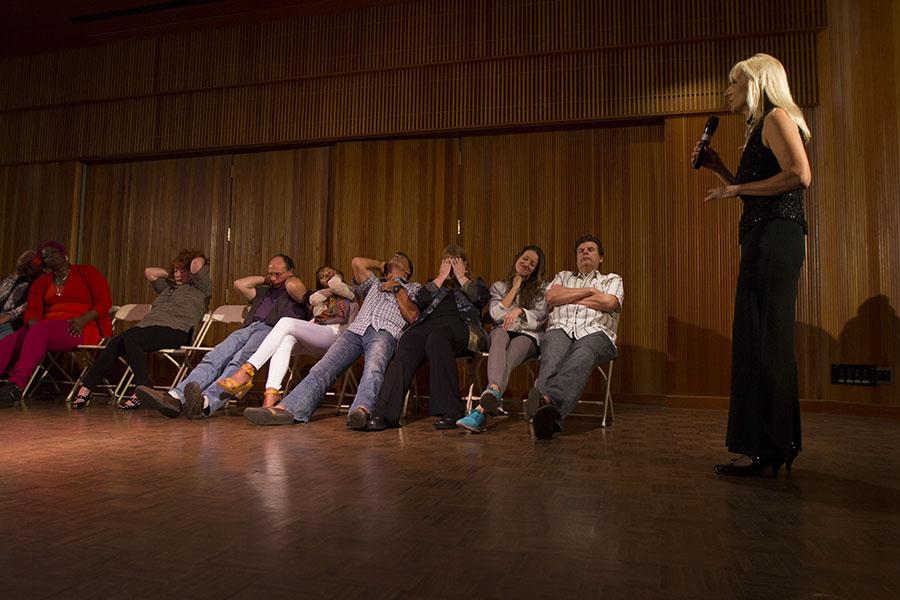 Volunteers from the audience have been put to sleep by hypnotist, Nancy Segal (right), inside the City College Fé Bland Forum, Friday Feb. 21. Segal is a hypnotist and spiritual healer who began her practice after using hypnotism to self-heal her body from mercury poisoning.