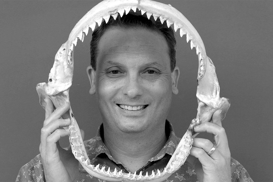 Blake Barron holds the jaws of a shark.