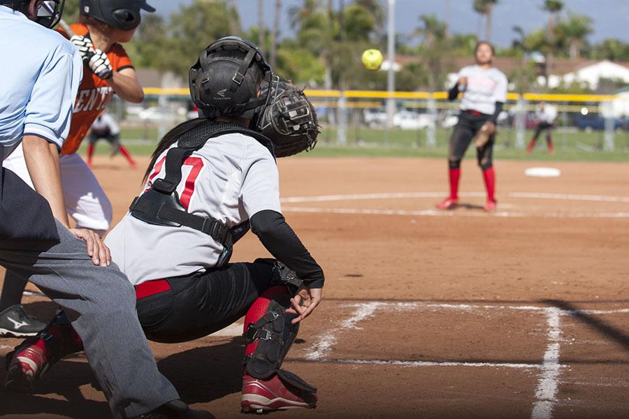 Vaqueros’ catcher Dakotah Wilcox (No. 10) reaches for the ball thrown by pitcher Celeste Acosta as Ventura’s Emily Heath gets ready to swing Thursday, March 20, at Pershing Park in Santa Barbara. The Vaqueros won the game against Ventura, 4-3.