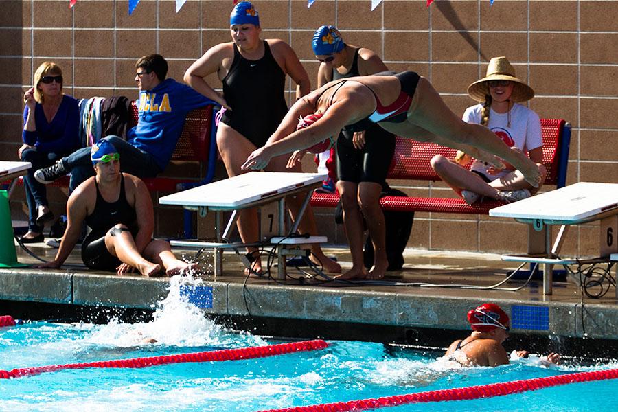 City College swim team member Sarah Westmoreland leaps from the starting block after teammate Janina Schulz completes her leg of the women’s 400 yard freestyle event on Friday, March 28, at San Marcos High School in Santa Barbara. The relay team took third place with a time of 4:06.71, despite some confusion with their starting gate, because of the fact that the lead off swimmer Emily Foster had just exited the pool after finishing her 100 yard breaststroke event.