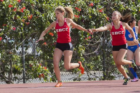 City College freshman sprinter, Courtney Linhares, hands the baton to freshman Alyssa Garrett during the 4x200-meter relay at La Playa Stadium on Friday, March 21, in Santa Barbara. Linhares and Garrett competed in the event with fellow track members Marla Bonser and Christina Khalil.