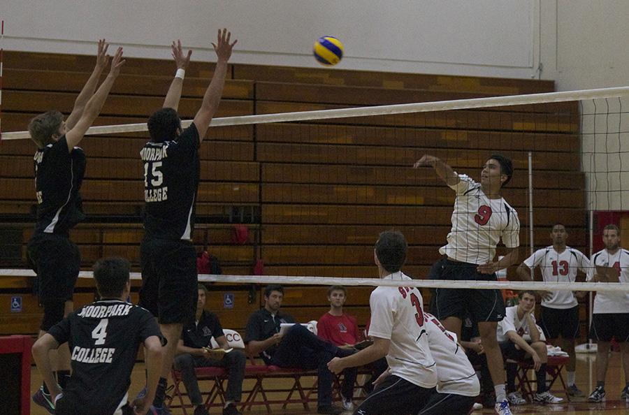 Vaqueros Opposite Hitter Evan Yoshimoto (No. 9) spikes the ball through Moorpark College's blockers Sean Ring (No. 7) and Brandon Kohler (No. 15) during the volleyball match on Friday, March 14, at the Sports Pavilion in Santa Barbara. The Vaqueros lost in four sets, 1-3.