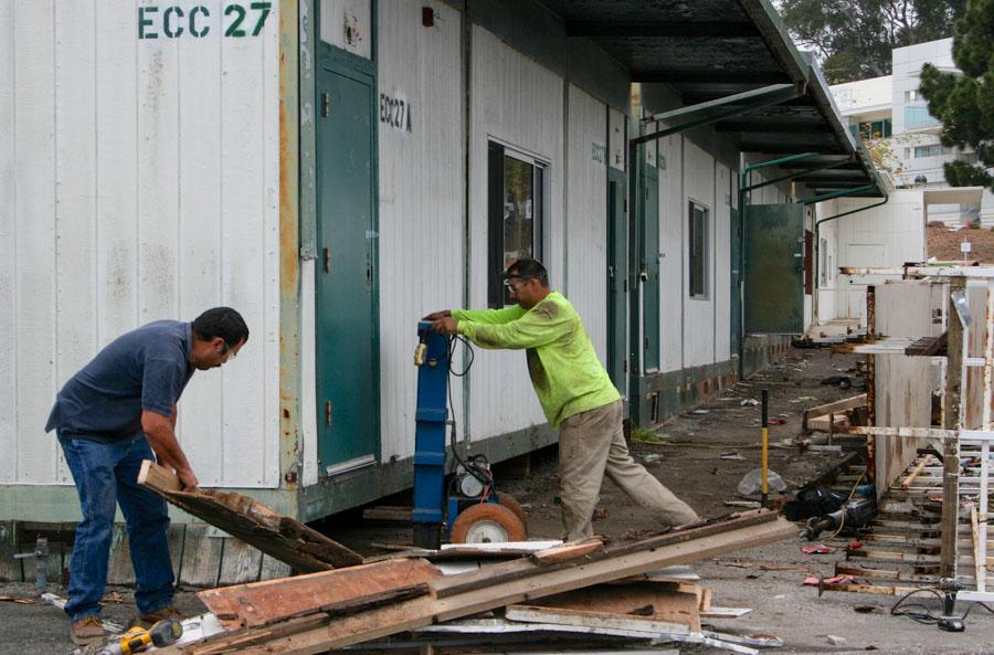 Pedro Zaragoza (left) and Antonio Piñela work on removing a portion of the East campus portables on Monday, March 24, at Santa Barbara City College. The portable buildings will be removed in phases and the newly cleared area will soon be home to drought tolerant plants.