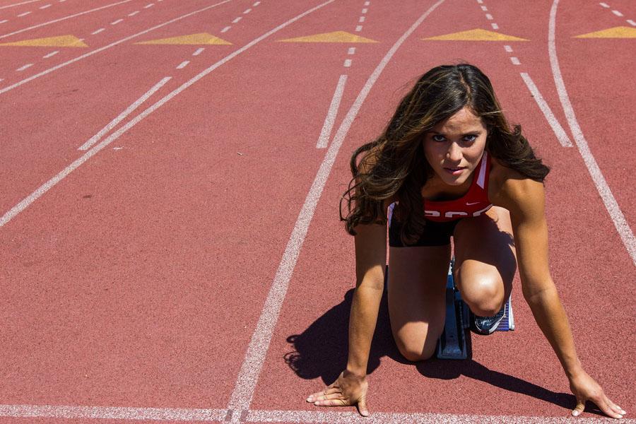 City Colleges freshman track and field athlete, Jessica Escalante, sets her position on the starting blocks on Friday, April 11, at La Playa Stadium in Santa Barbara. Escalante, 19, recovered from three knee surgeries to become a sprinter and javelinist on the team.