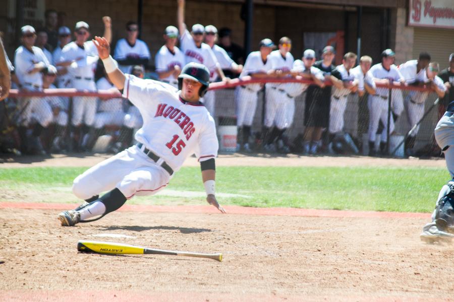 Designated hitter Jimmy Hill (No. 15) slides safely into home in the first game of the Super Regional series against LA Mission, Friday May 10, at Pershing Park. The Vaqueros defeated the Eagles, 3-0, and are one win away from moving on to Sectionals.