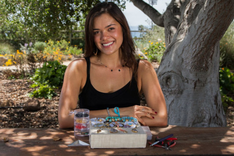 Brianna Daniels shows her hand made jewelry, Thursday, May 1, 2014, at the Lifescape gardens at Santa Barbara (Calif.) City College’s East Campus. Daniels owns her own jewelry business called Studio 399 Jewelry.