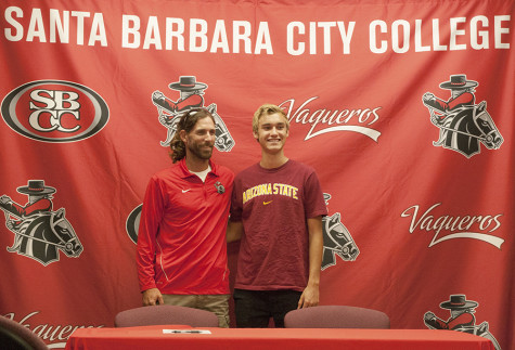 Cross Country Runner Ian Roberts shares a moment with coach Scott Fickerson after signing his letter of intent to Arizona State University, Thursday, May 8, at the Sports Pavilion. Roberts was named the 2013-2014 Male Athlete of the Year.  