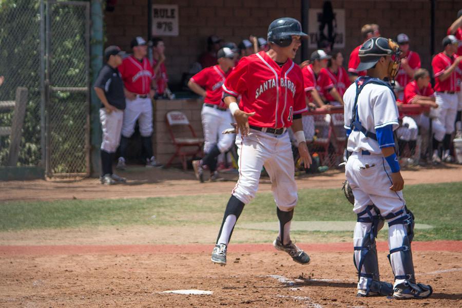 City Colleges freshman outfielder, Brandon Evans (No. 14), celebrates earning a run after Patrick OBriens double base hit during the fourth inning on Saturday, May 3, at Pershing Park in Santa Barbara. The Vaqueros defeated the San Bernardino Valley College Wolverines 8-2, advancing to the second round of the 2014 CCCAA Baseball Southern California Regional for the second time in school history.