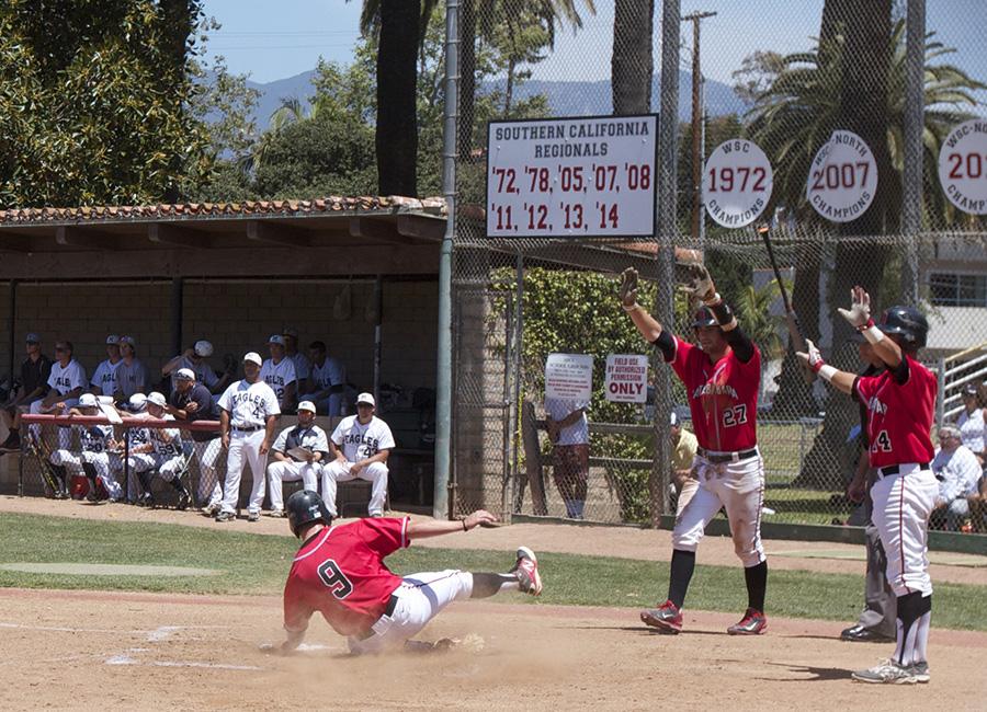Jimmy Brakka (No. 9) slides in safely to home as Patrick O’Brien (No. 27) and Brandon Evans (No. 14) wait to congratulate him, Saturday May 10, at Pershing Park. The Vaqueros’ 8-1 win against LA Mission in game two of the best-of-three series advances them to the Sectionals round for the first time in program history.  