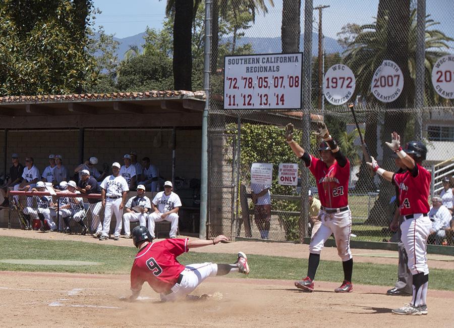 Jimmy Brakka (No. 9) slides in safely to home as Patrick O’Brien (No. 27) and Brandon Evans (No. 14) wait to congratulate him, Saturday May 10, at Pershing Park. The Vaqueros’ 8-1 win against LA Mission in game two of the best-of-three series advances them to the Sectionals round for the first time in program history.