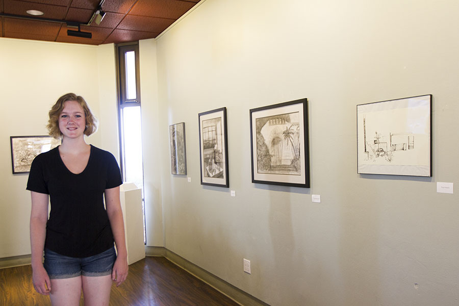 Ryan Peters curates the shows in the Annex Gallery, one of her duties as gallery intern for the art department, Wednesday, Sept. 17, on East Campus in Santa Barbara. I like to work in the gallery because I love to share my enthusiasm for art with other people, said Peters.