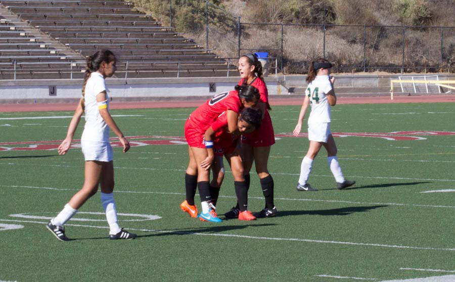 Santa Barbara City College forward Laura Romero (No. 20) and defender Mackenzie Rios (No. 10) celebrate with forward Sandy Grimaldo (No. 13) after Grimaldo’s game winning goal in the 91st minute of the Vaquero’s 1-0 victory Friday, Sept. 26 over the Los Angeles Valley College Monarchs