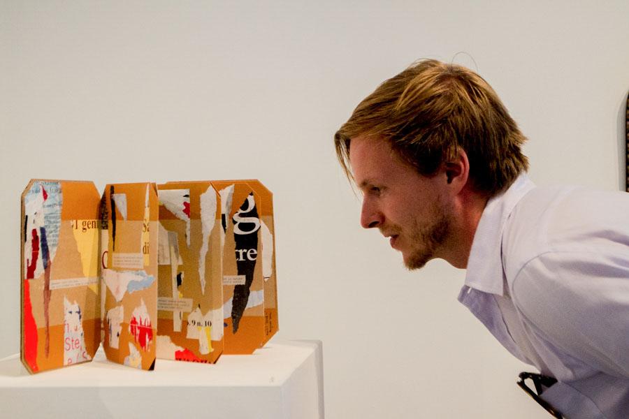 Adjunct faculty member Kevin Evans stops to contemplate the collage After Words, at the City College Art Faculty Biennial on Friday, August 29, in the Atkinson Gallery. This piece was created in 2012 by art history professor Thomas Larson, and is on display until Sept. 26.