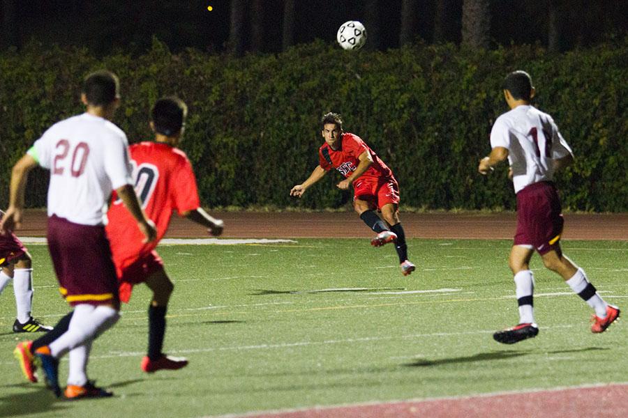 Vaqueros midfielder Enrique Fernandez (No. 8) shoots over the defense during City Colleges first win of the season against the Pasadena Lancers, Tuesday, Sept. 16 at La Playa Stadium. The Vaqueros won the game 2-1.
