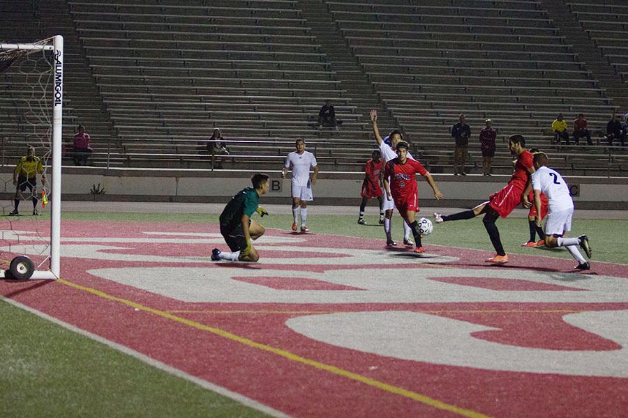 Vaquero's center forward Medhi Badache (No. 6) scores his third goal of the game for the hat trick, after a shot by teammate Omar Montalvo (No. 11) was deflected by a Citrus College Owl's player, Tuesday, Oct. 7, 2014, at La Playa Stadium at City College in Santa Barbara, Calif. This goal put the Vaqueros up 4-3, securing their victory and giving coach John Sisterson his 100th win as the City College men's soccer beat Citrus College 4-3.
