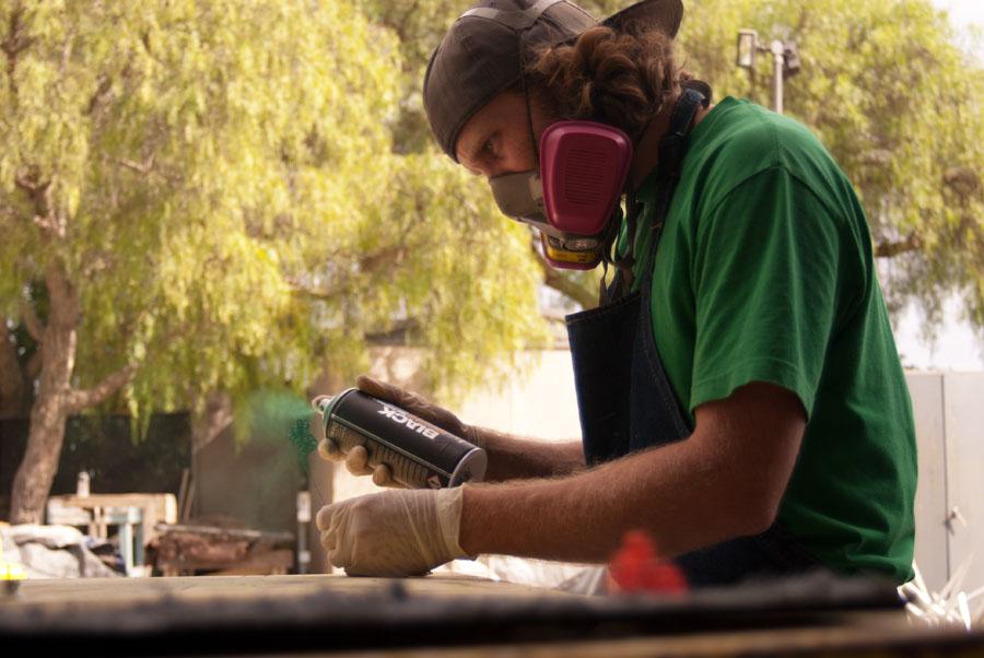 City college art student, Ben Eckert, uses his new green spray paint to paint his sculpture on Wednesday, Oct. 15, in Santa Barbara, Calif. Eckert said, "I just recently got this spray paint and I really like the shade." His favorite color is green.