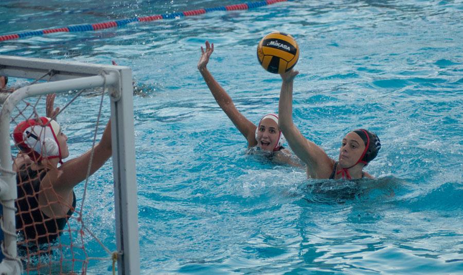 City college women's waterpolo utility player, Abdiel "AJ" Gravatt (No.17) scores against Pierce College goalie Sarah Karp (No.1) and field player Isabella McNealy (No.6) during the game at San Marcos High School in Santa Barbara, Calif. on Wednesday, Oct. 22, 2014. The Vaqueros beat the Brahmas 12-6.