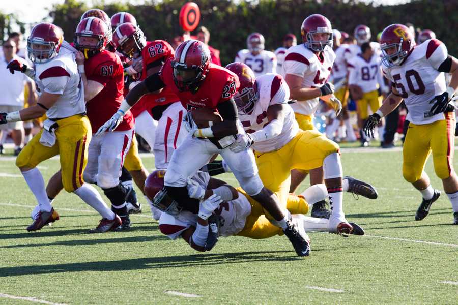 City College running back Marvin Millett (no. 27) struggles to fight his way past a Glendale linebacker in order to make a first down in City Colleges game against Glendale Community College at La Playa Stadium on November 15. Glendale beat City College 47-14 ending any hope for a City College bowl game appearance.