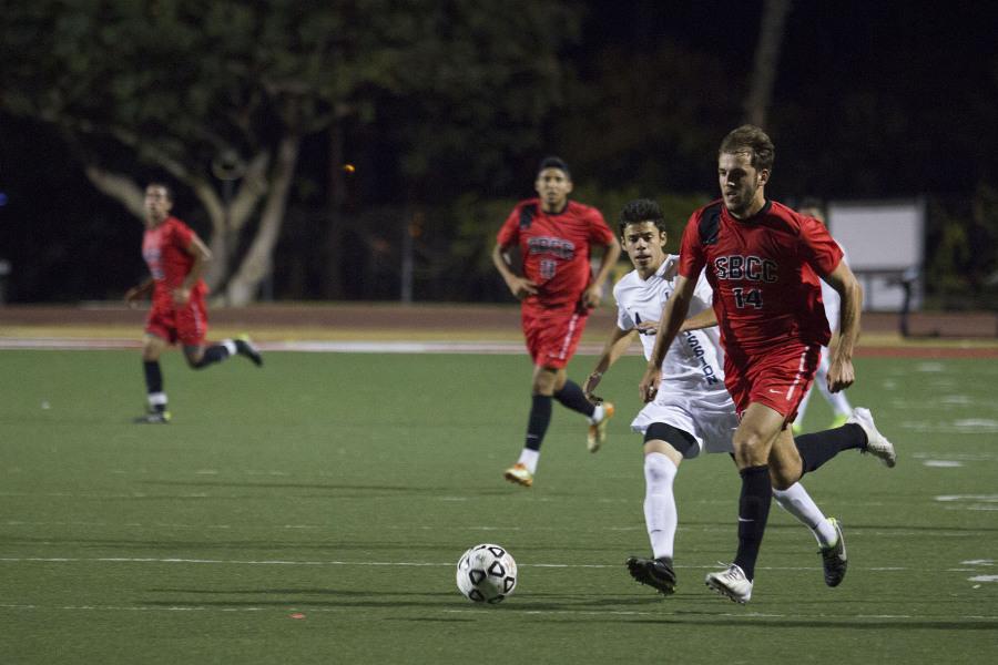 Santa Barbara City College defender Albi Skendi (No. 14) takes the ball down the pitch during the Vaqueros game against LA Mission Tuesday, Nov. 4 at La Playa Stadium in Santa Barbara, Calif. Skendi scored the second goal in the final minute of play to tie the game.