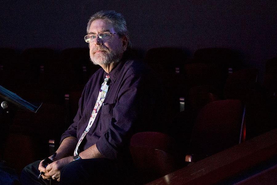 Associate theatre professor Michael Gros looks out at students rehearsing for the upcoming production of "Ten Red Kings," on Thursday, Nov. 6, in the City College Jurkowitz Theatre.