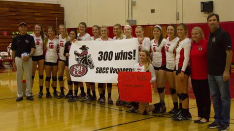 Ed Gover (black), head coach of the Santa Barbara City College Women's Volleyball team, and his team celebrate Gover's 300th career win Wednesday night Nov. 12, after the Vaquero's defeated the Ventura College Raiders 3-0 at Santa Barbara City College, Santa Barbara, Calif.