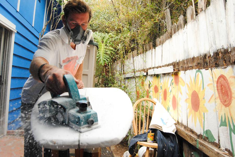 City College student Cooper Hamilton shapes blanks and fixes boards in the backyard of his Isla Vista house, Tuesday, Nov. 11. Hamilton is the founder of Yafaa Surfboards, a name inspired from his travels in Swahili, meaning “better” surfboards.