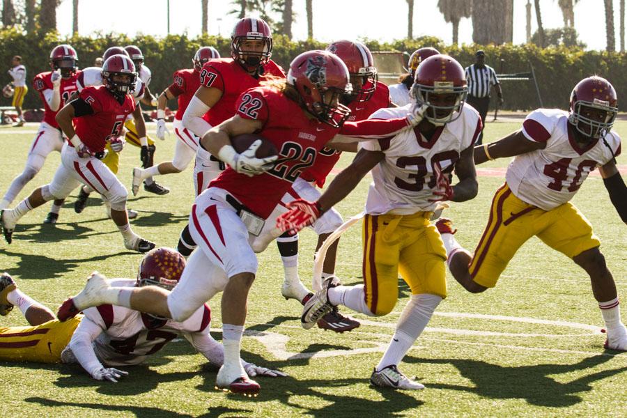 Vaquero wide receiver and kick returner Tyler Higby (No. 22) stiff-arms Glendale’s starting linebacker Chris Riley (No. 33) on a kick return in the beginning of City Colleges game against Glendale Community College Nov. 15, in Santa Barbara at La Playa Stadium.