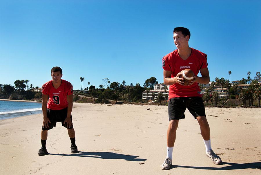 City College running back Cedric Cooper (left) and quarterback Brandon Edwards set up to do a quick handoff at Leadbetter beach, Wednesday, Nov. 5, in Santa Barbara, Calif. The two athletes embrace the sunny beach, coming from Seattle, Wash.