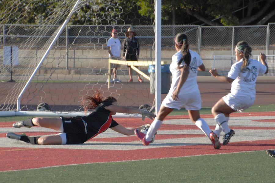 Santa Barbara City College goalkeeper Kasey Jensen (No.1) makes one of her saves against Moorpark College forward Angela Hurtado (No.14) and defender Jenna Brooskin (No.28) at La Playa Stadium on Tuesday, Nov. 4. Jensen was perfect in her goalkeeping in the Vaqueros 2-0 win over Moorpark College.