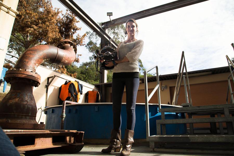 Riley Booth, one of only two females in the Marine Diving Program this semester at City College, stands with the Kirby Morgan SuperLite 27 helmet in the Marine Technology Building at City College, Thursday, Dec. 4. ‘I think when girls realize there’s nothing limiting them just based on their sex...a lot of girls might be interested in this kind of thing,’ said Booth.