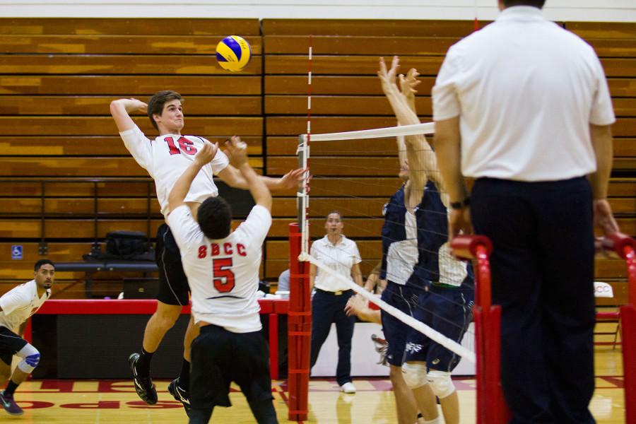 Keaton Arutian (No. 5) sets up the ball for City College middle blocker Jeremy Burch (No. 16) to hit and score a point during the third set, Wednesday, Feb. 11, in the Sports Pavilion at Santa Barbara City College. The Vaqueros won 3-2 against Irvine Valley College.