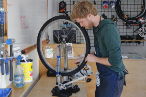 Student worker Kevin McClintock works on straightening a students wheel at the new Bici Centro station, Wednesday, Feb. 18, located on the East Campus Bridge entrance at City College. This new do-it-yourself bike shop is open from 10 a.m. to 2 p.m. Monday through Thursday.