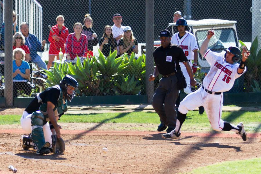 City College catcher James Hill (No. 15) slides in to score a run against Cuesta College, Tuesday, Feb. 24, at Pershing Park in Santa Barbara. The Vaqueros beat the Cougars 4-0.